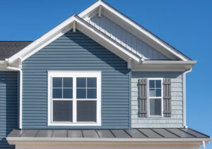 Home with blue fiber cement siding at day